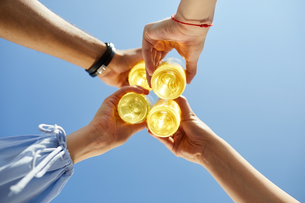 Hands raised with cocktail in hand
