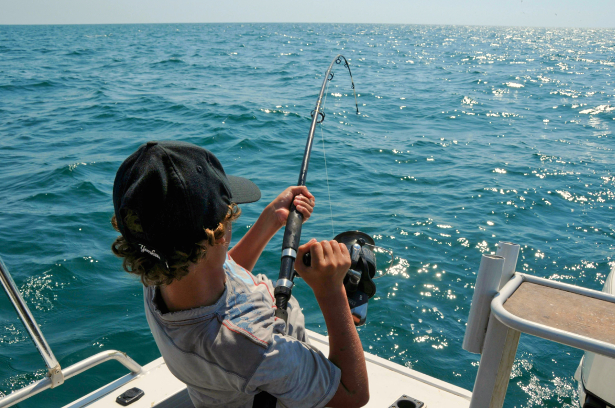 Young fisherman catching a fish on the St John's River in Putnam County Florida.